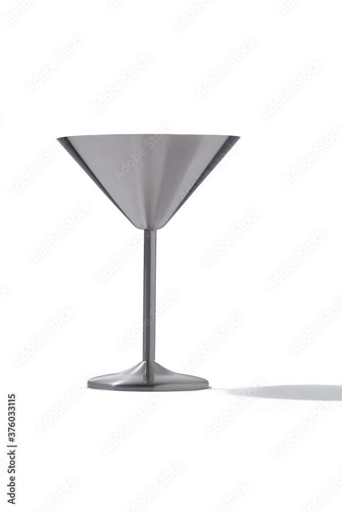 Detailed shot of metal cocktail glass with satin surface. The stainless steel cocktail glass is isolated on the white background. Detailed shot of metal cocktail glass with satin surface. The stainless steel cocktail glass is isolated on the white background.
