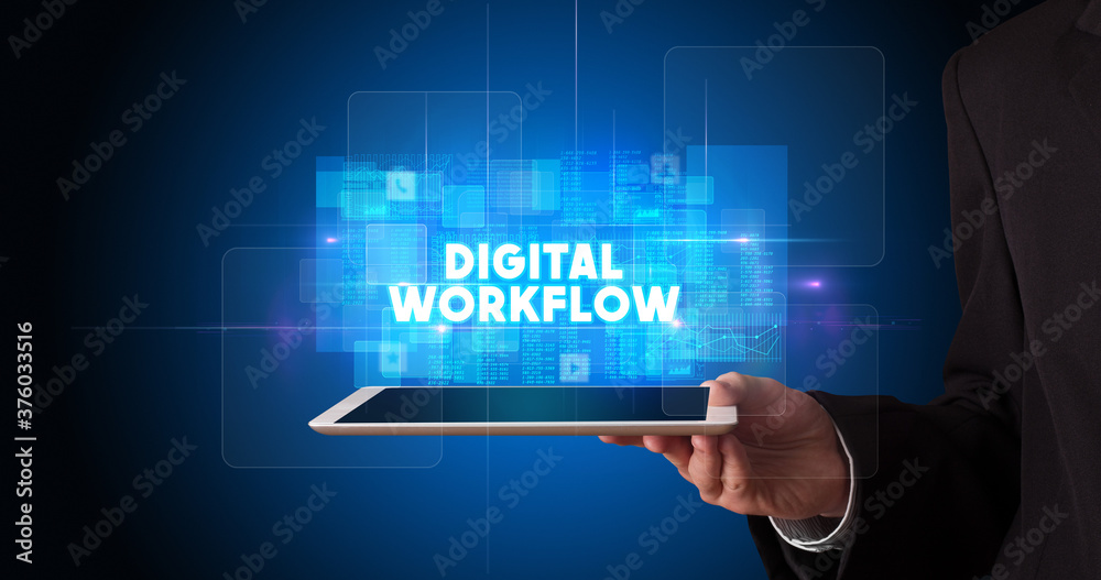 Young business person working on tablet and shows the inscription: DIGITAL WORKFLOW Young business person working on tablet and shows the inscription: DIGITAL WORKFLOW