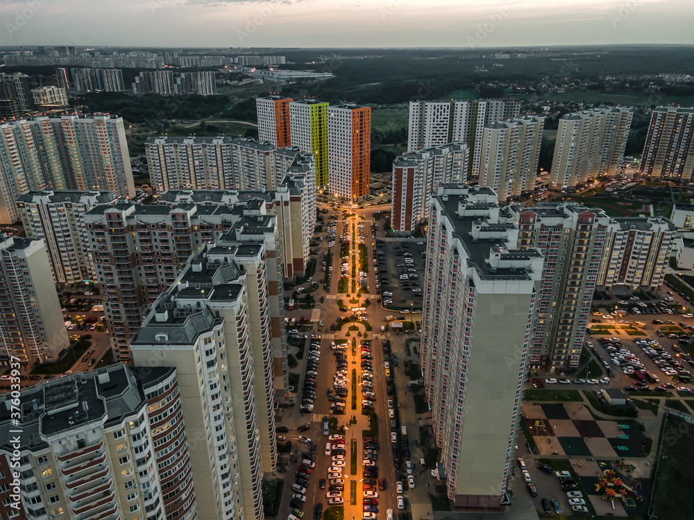 City street and high skyscrapers in the evening