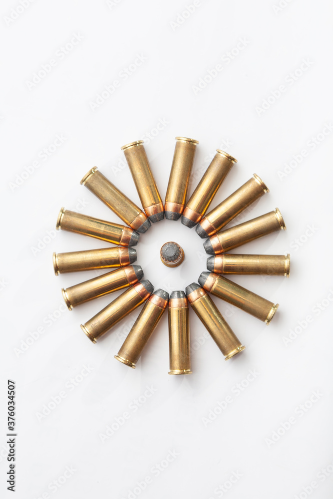 A circle formed by several brass bullets, ammunition for a revolver.