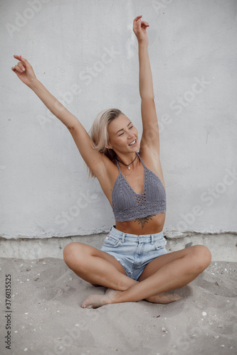 Happy young pretty blond woman at the beach