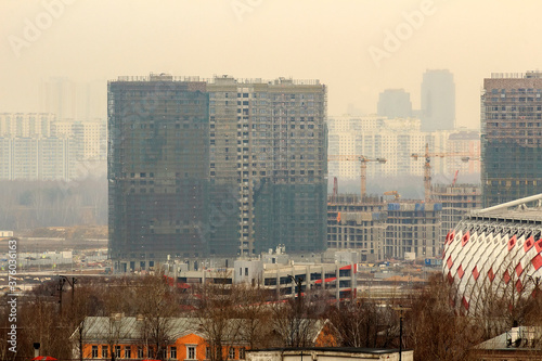 Construction of a monolithic house. Stylobate. Construction site residential house, office apartment. High-rise facade of multi-story. Monolithic brick structure. Rainscreen is exterior wall photo