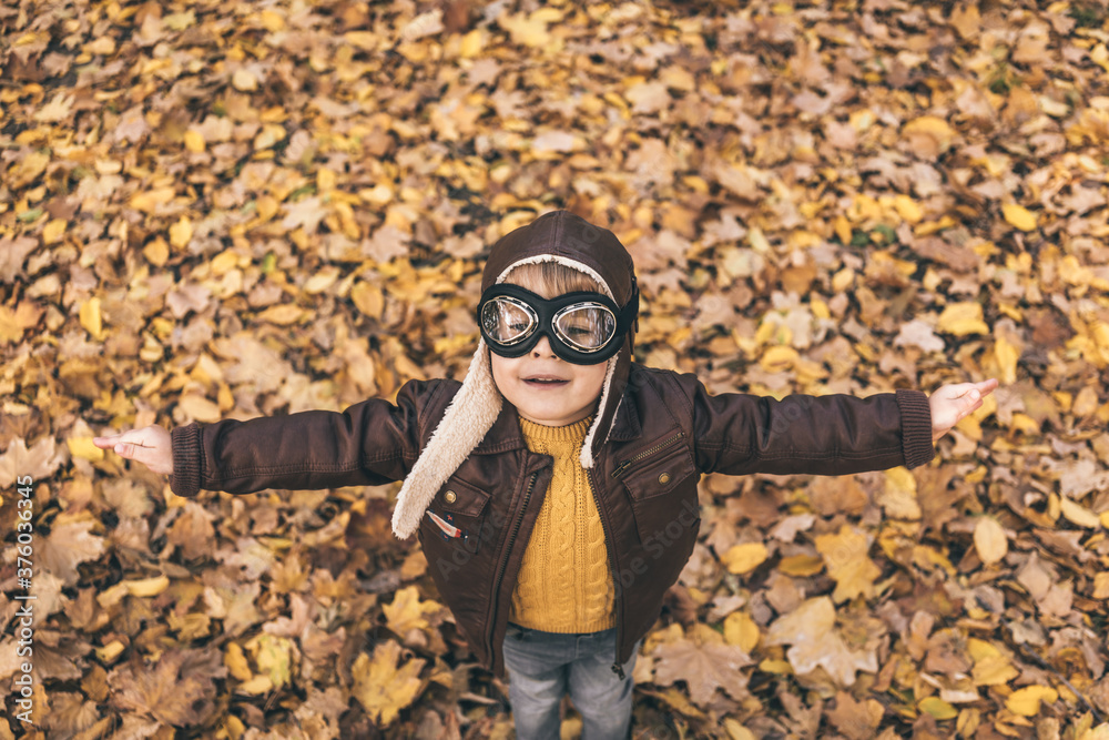 Happy child having fun outdoor in autumn park Happy child having fun outdoor in autumn park