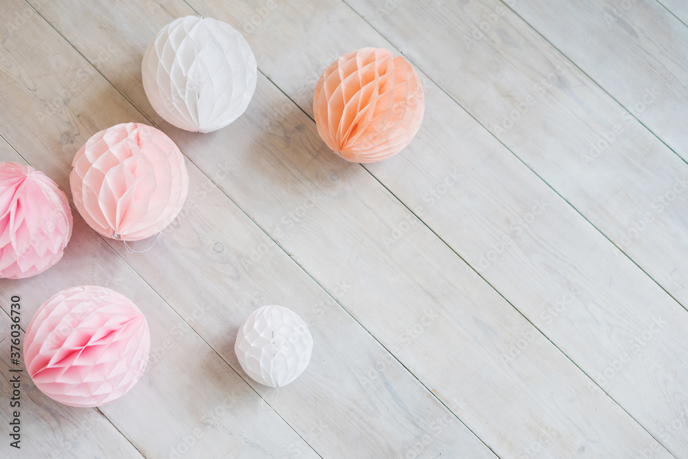 Tissue Paper Honeycomb Balls on a white wood floor. Pink party decor. Tissue Paper Honeycomb Balls on a white wood floor. Pink party decor.