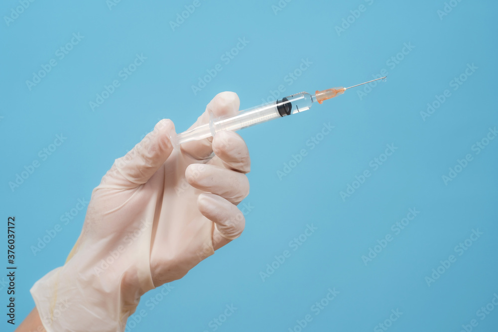 Syringe in doctor hand