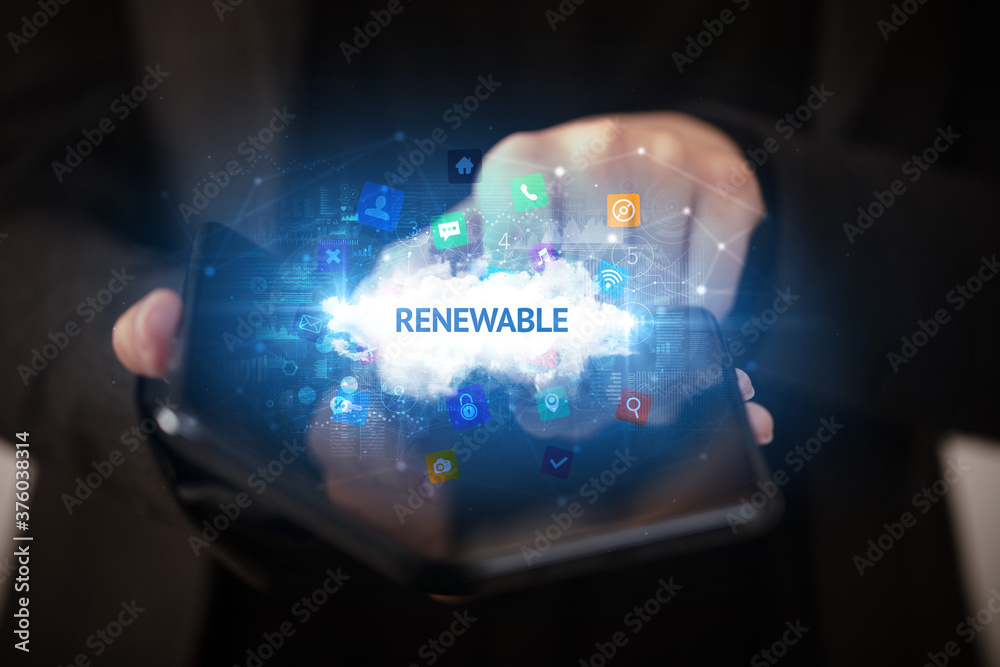 Businessman holding a foldable smartphone with RENEWABLE inscription, technology concept Businessman holding a foldable smartphone with RENEWABLE inscription, technology concept