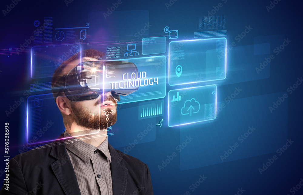 Businessman looking through Virtual Reality glasses with CLOUD TECHNOLOGY inscription, new technology concept Businessman looking through Virtual Reality glasses with CLOUD TECHNOLOGY inscription, new technology concept