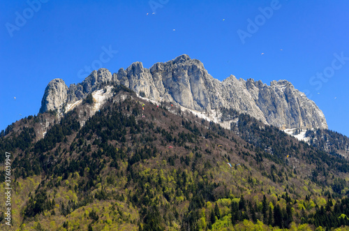 A mountain without a name in the Lake Annecy area and paratroopers using it for jumping and flying. At the foot of the mountain is the famous castle Menthon-Saint-Bernard