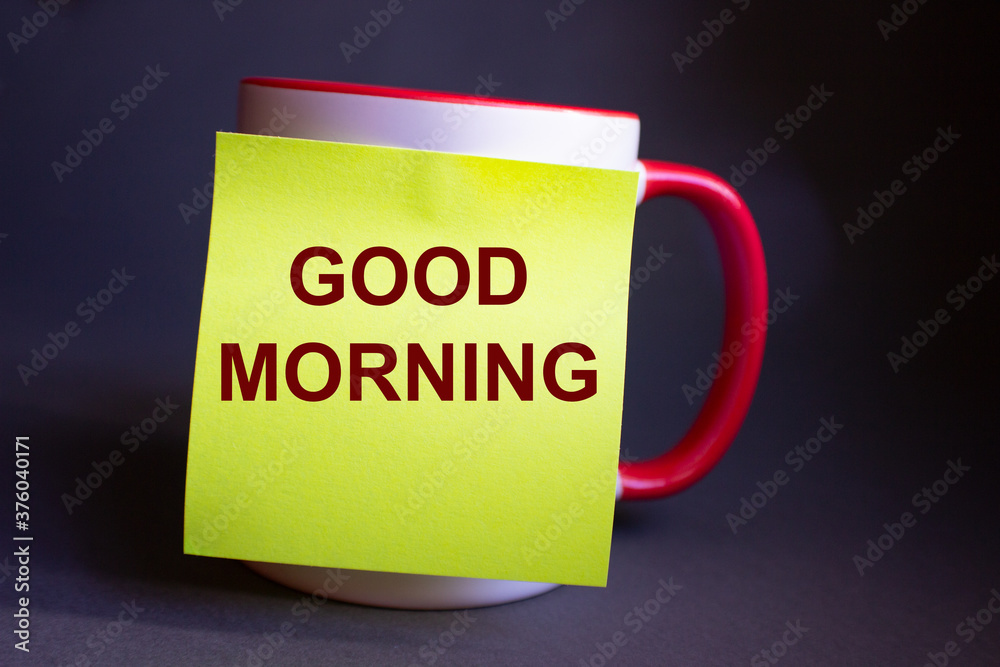 The inscription good morning on a yellow paper sheet pasted on the cup. The inscription good morning on a yellow paper sheet pasted on the cup.