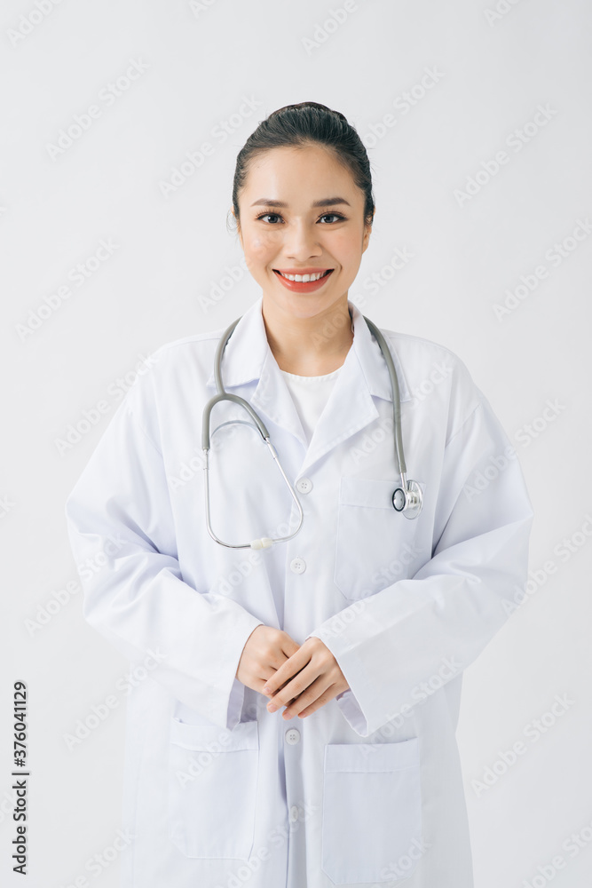 Portrait of glad smiling doctor in white uniform standing with crossed hands on white background Portrait of glad smiling doctor in white uniform standing with crossed hands on white background