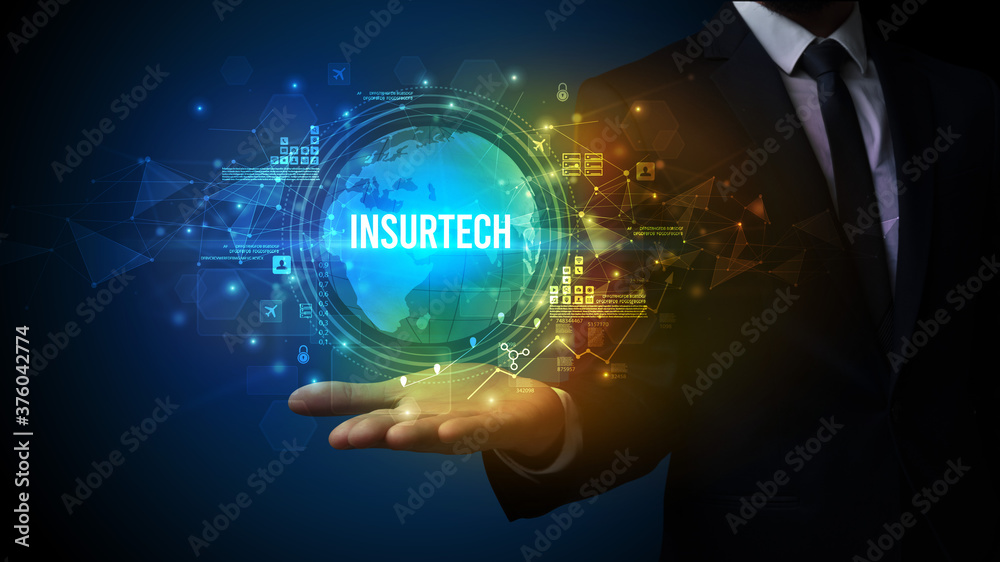 Elegant hand holding INSURTECH inscription, digital technology concept Elegant hand holding INSURTECH inscription, digital technology concept