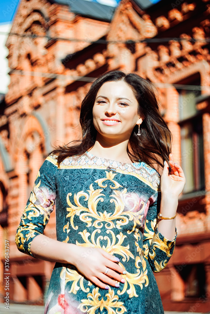 Autumn portrait of happy young woman in black dress walking in city in gold october. Fall season. Beautiful happy people. 