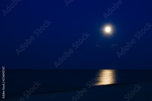Fototapeta Naklejka Na Ścianę i Meble -  A Moon with reflection by the sea on nature background
