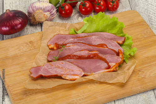 Sliced smoked duck breast served salad