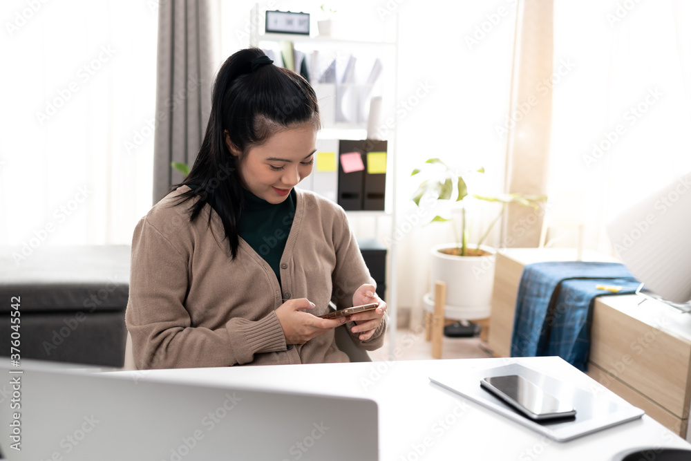 Young Asian woman using mobile phone for communication Young Asian woman using mobile phone for communication
