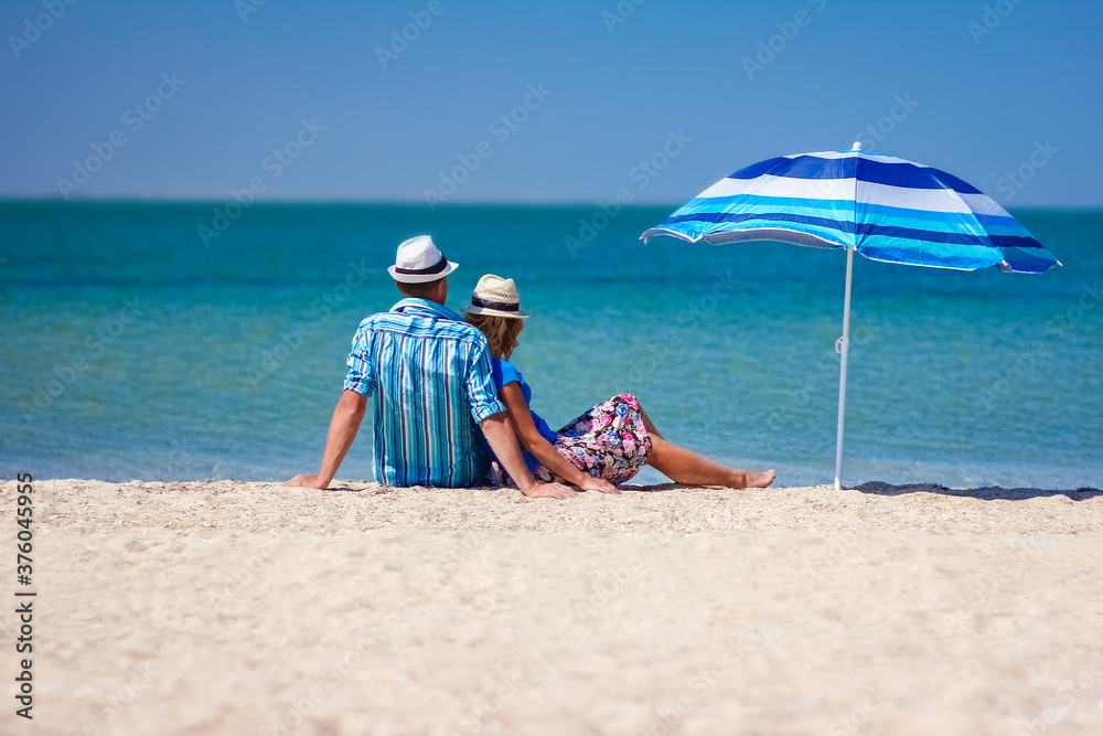 A Happy couple guy with girl by the sea on nature travel A Happy couple guy with girl by the sea on nature travel