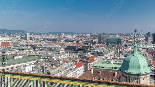 Panoramic aerial view of Vienna, austria, from south tower of st. stephen's cathedral timelapse. City skyline with historic buildings roofs from above at sunny day photo