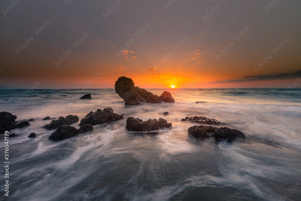 Look at the sunset from the beach of Ilbarritz's rocks at Biarritz, in the Basque Country.	