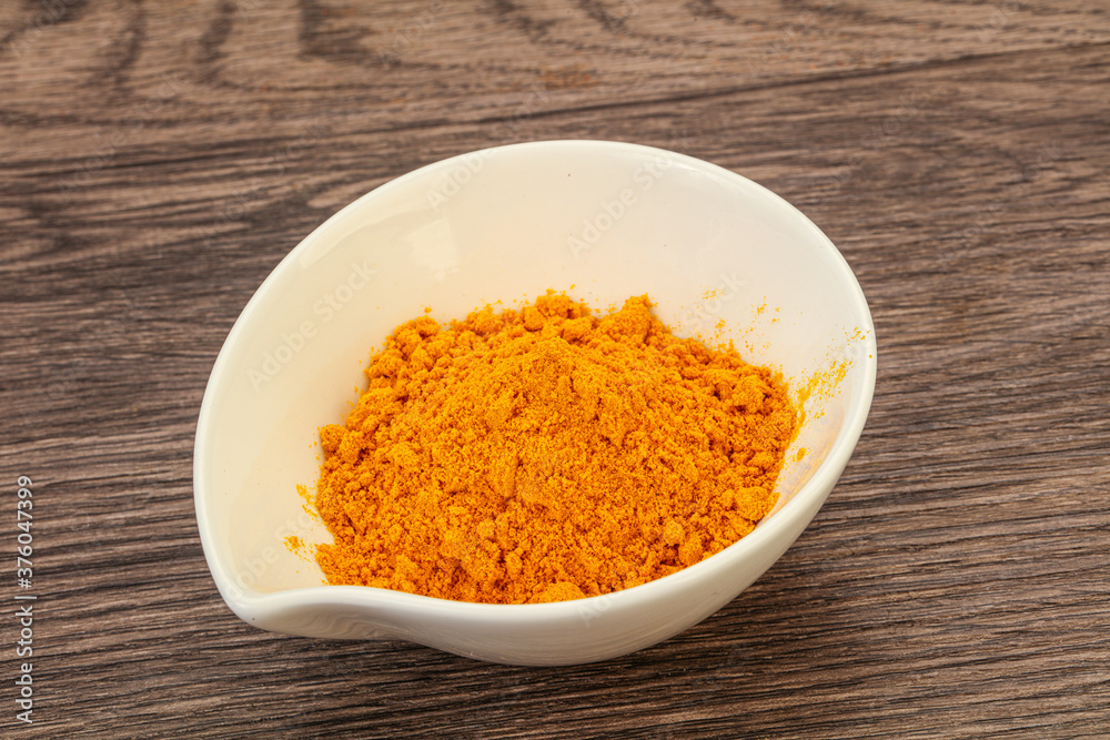 Tumeric powder in the bowl Tumeric powder in the bowl