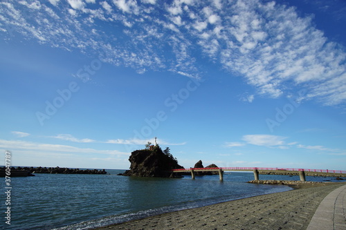 Wallpaper Mural A beautiful blue sky behind a lighthouse and a red bridge in the beach, Japan Torontodigital.ca