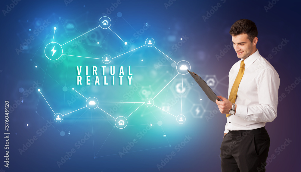 Businessman in front of cloud service icons with VIRTUAL REALITY inscription, modern technology concept Businessman in front of cloud service icons with VIRTUAL REALITY inscription, modern technology concept