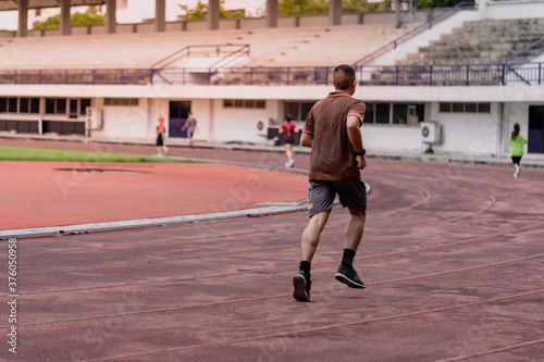 Fototapeta Naklejka Na Ścianę i Meble -  People jogging in public running fields