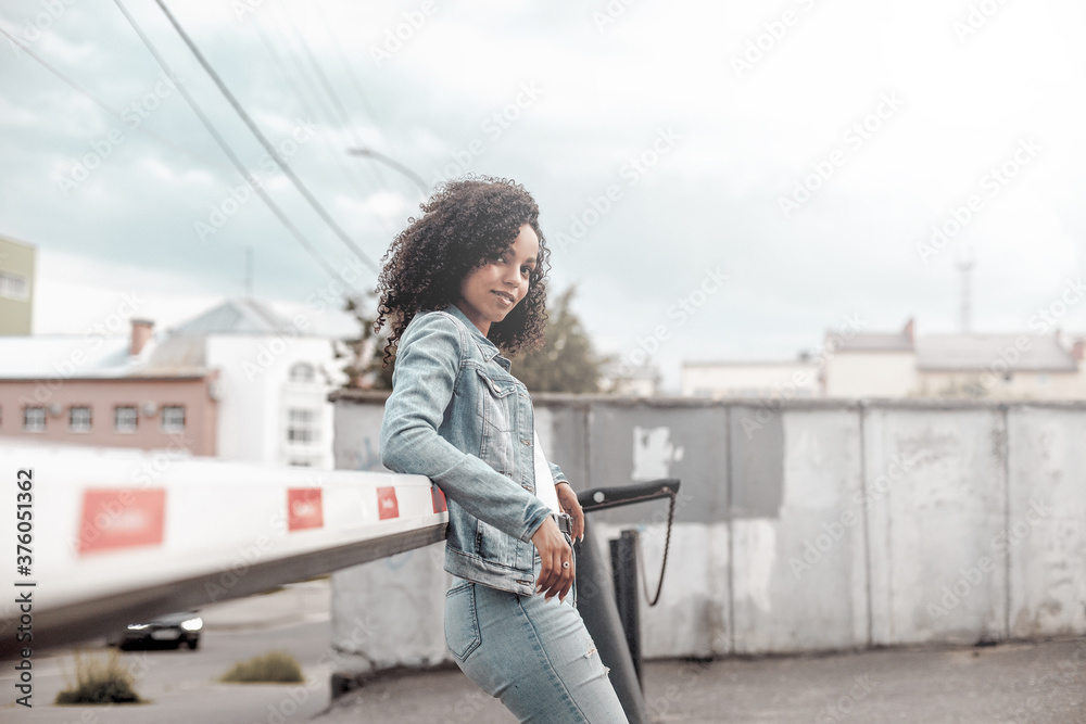 black curly girl on street