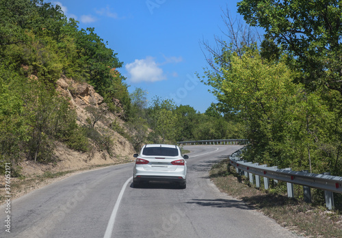 Car move along a winding mountain road © Yuri Bizgaimer