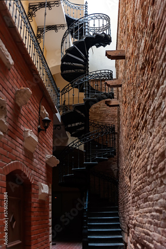 An old spiral staircase leading up in Lviv Ukraine photo