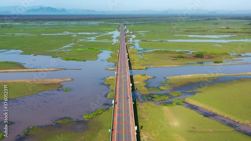 4K footage of Ekachai bridge Chalerm Phra Kiat 80 Phansa located at Thale Noi Wetland in Phatthalung, Thailand photo