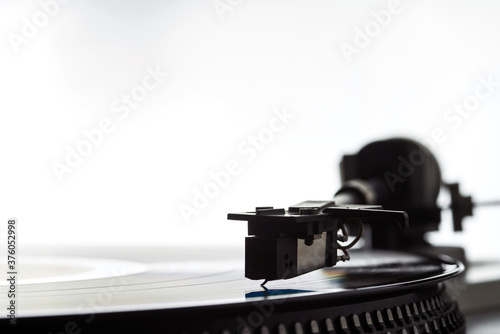 The needle on a vinyl record. Equipment for reproducing analog sound recordings.