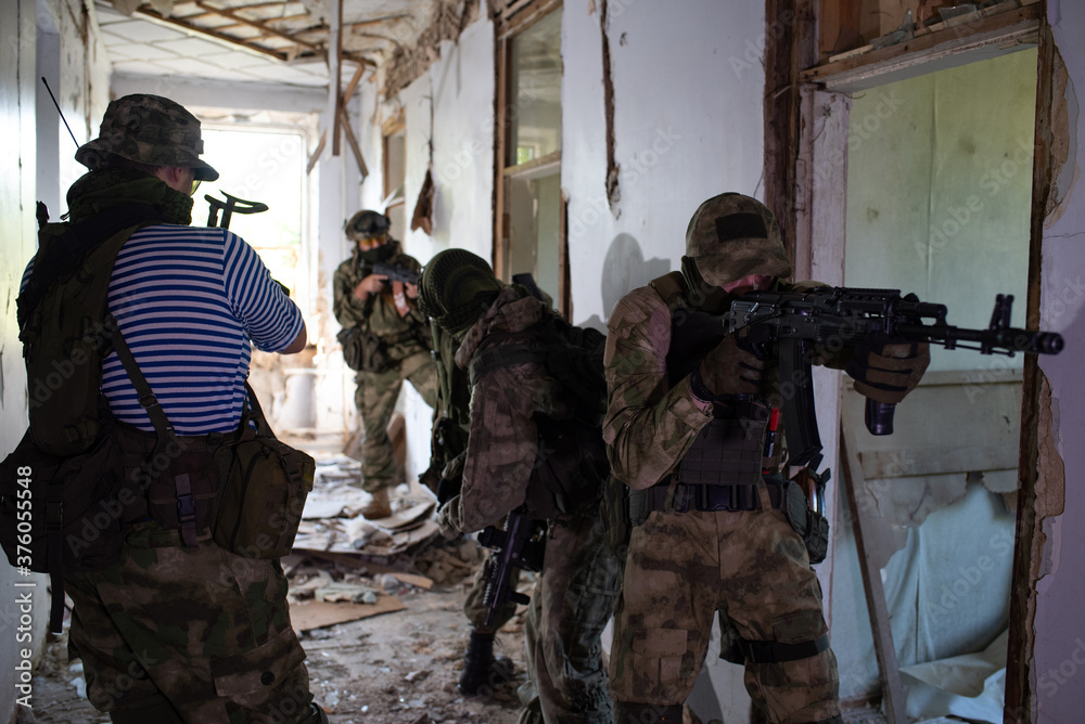 Fototapeta premium A team of professional airsoft players clear the location from opponents