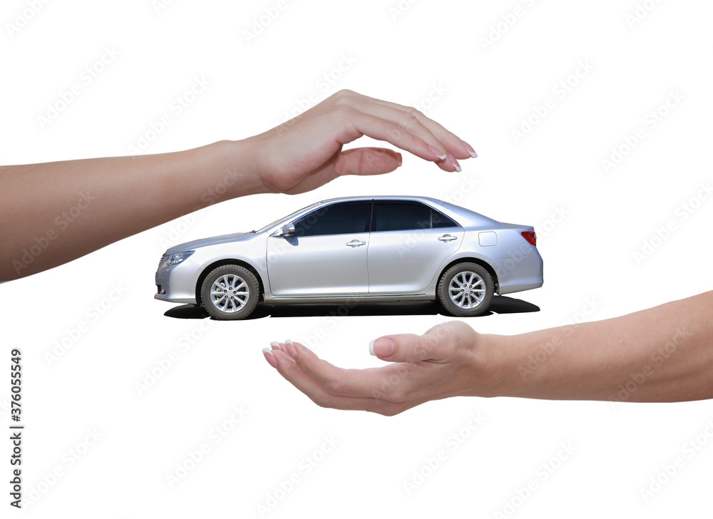 Female hands above and below the car