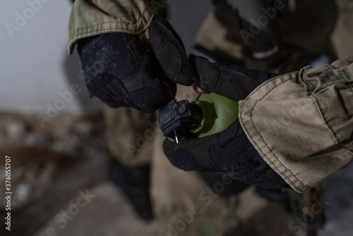 Close-up grenade in the hands of an airsoft player