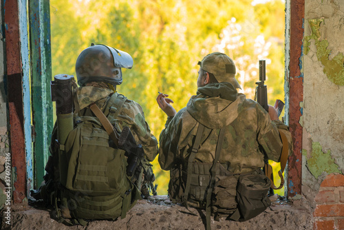 Two airsoft teammates on a smoke break photo