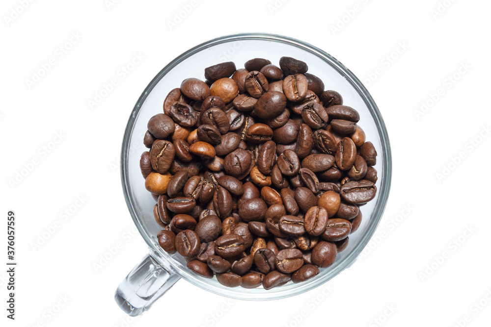 transparent cup full of roasted coffee beans on a white background. transparent cup full of roasted coffee beans on a white background.