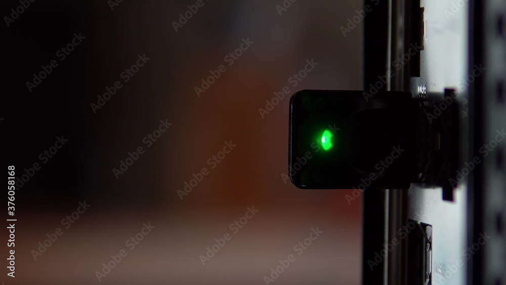 Usb modem wifi inserted into the computer closeup. The modem flashes a