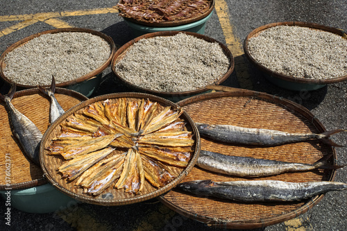 Sun dried fish on the road to used for cooking and sell in the seaside fishing market. Food preservation. 