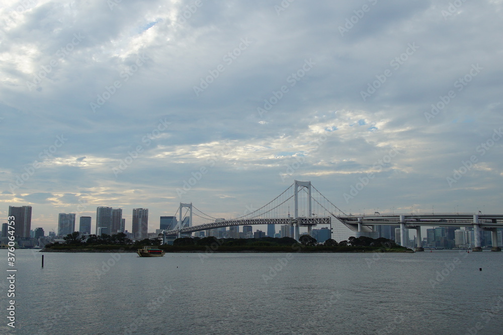 landscape of Odaiba rainbow bridge and cloudy sky, Tokyo, Japan landscape of Odaiba rainbow bridge and cloudy sky, Tokyo, Japan