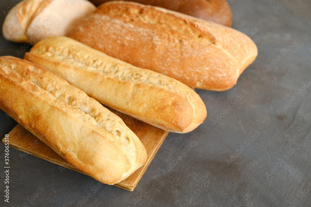 French baguette and loaf of ciabatta italian bread on table. Bakery concept.