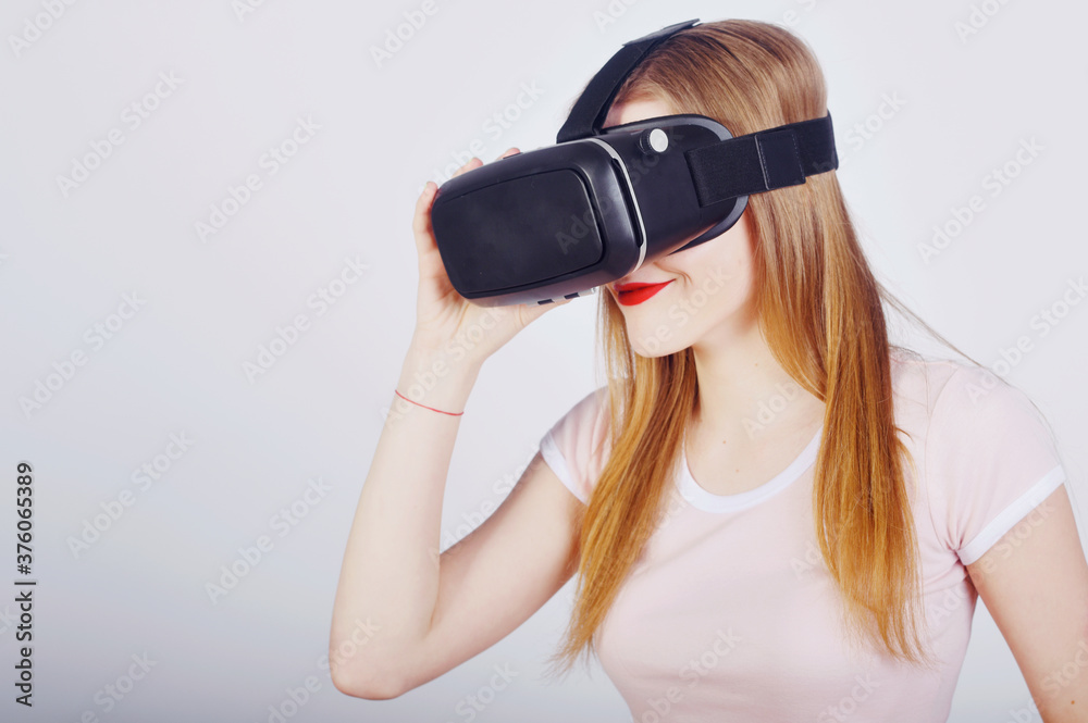 Girl on a white background plays virtual reality. Games and films vr. Emotions Girl on a white background plays virtual reality. Games and films vr. Emotions