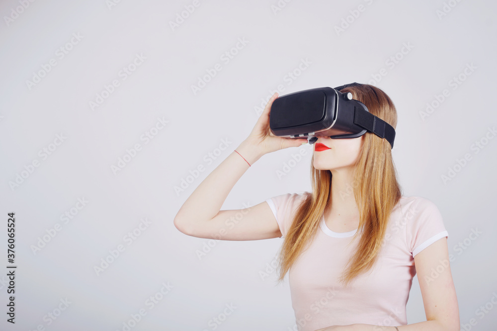 Girl on a white background plays virtual reality. Games and films vr. Emotions Girl on a white background plays virtual reality. Games and films vr. Emotions