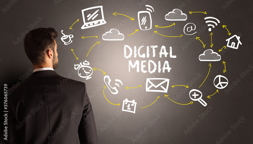 businessman drawing social media icons with DIGITAL MEDIA inscription, new media concept businessman drawing social media icons with DIGITAL MEDIA inscription, new media concept