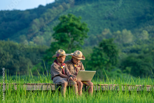Scouts are using laptop at scout camp. © visoot
