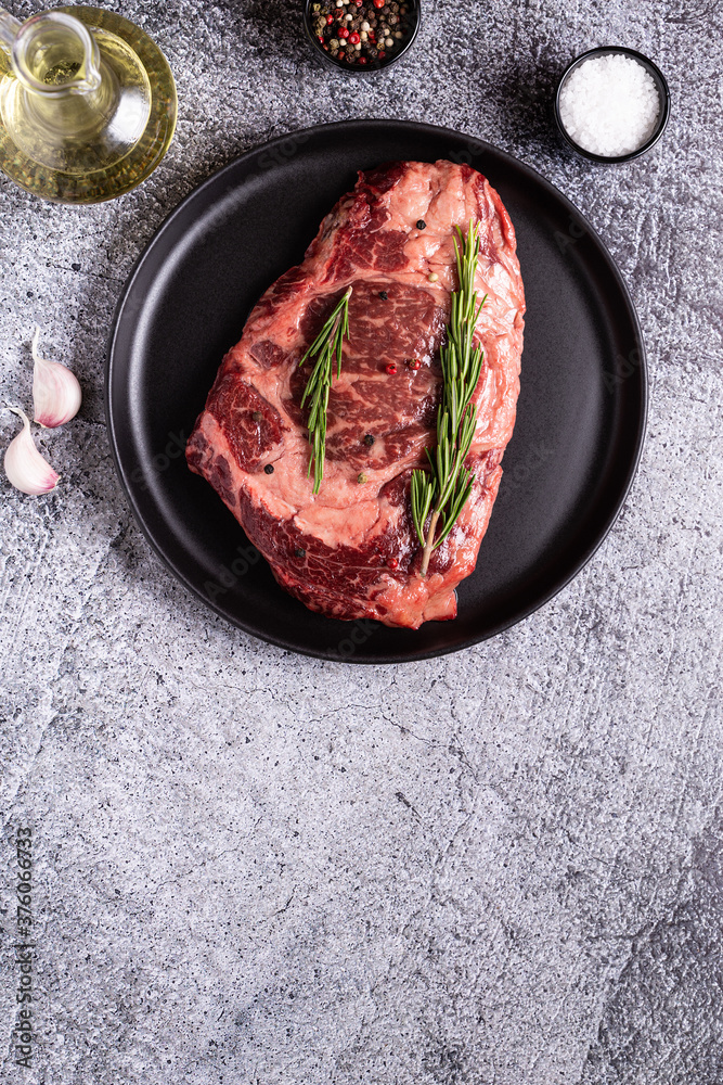 Fresh raw beef steak on black plate. Fresh raw beef steak on black plate.