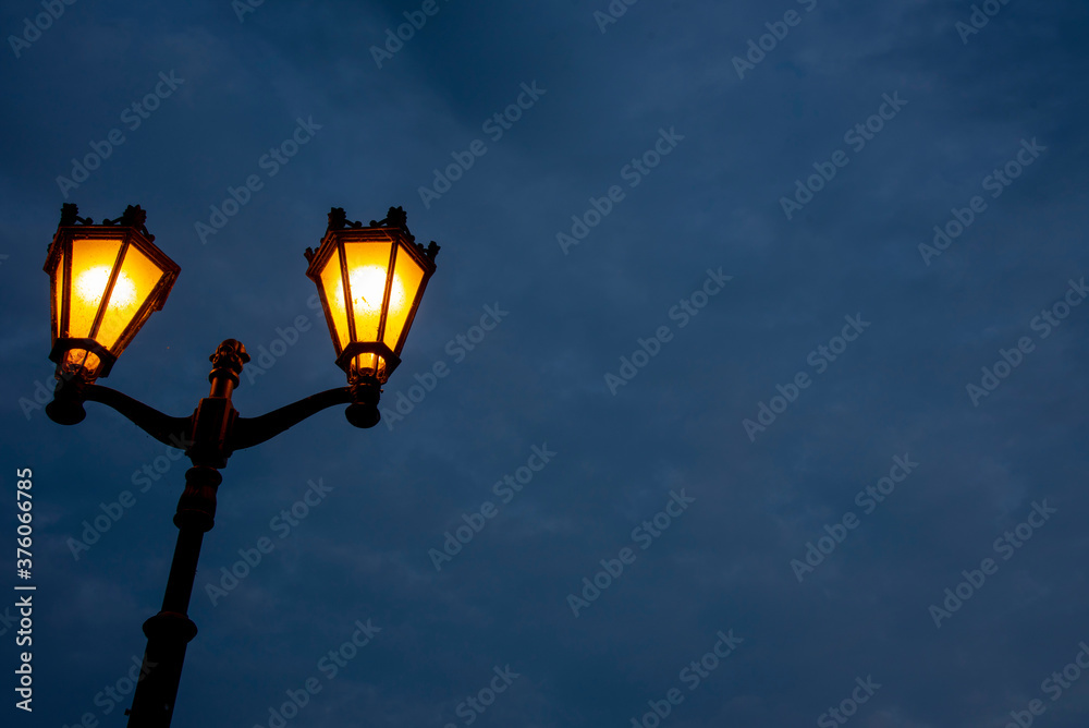 A bright yellow lantern against a dark sky. Background for Halloween. A bright yellow lantern against a dark sky. Background for Halloween.