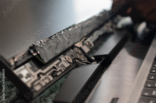 repairing gaming laptop and removing inner parts of gaming laptop screen in black