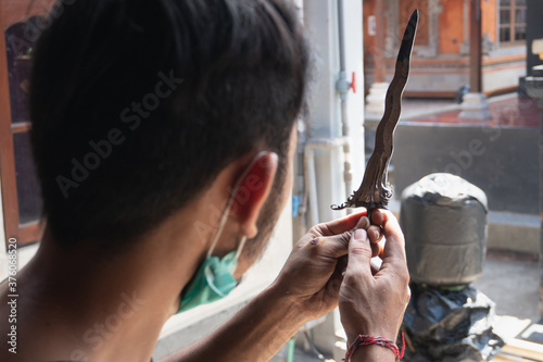 making traditional Balinese keris manually. The process of carving Balinese keris details are a little complicated and meticulous photo