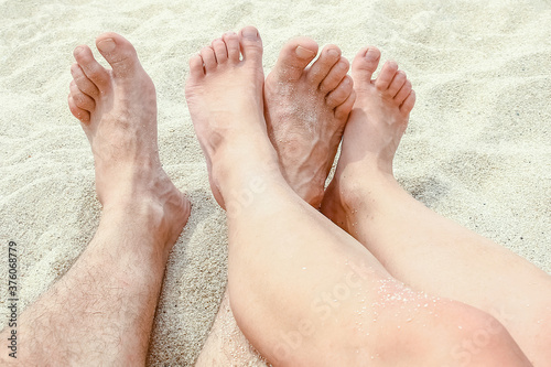 beautiful legs in the sand of the sea greece background © Kostia