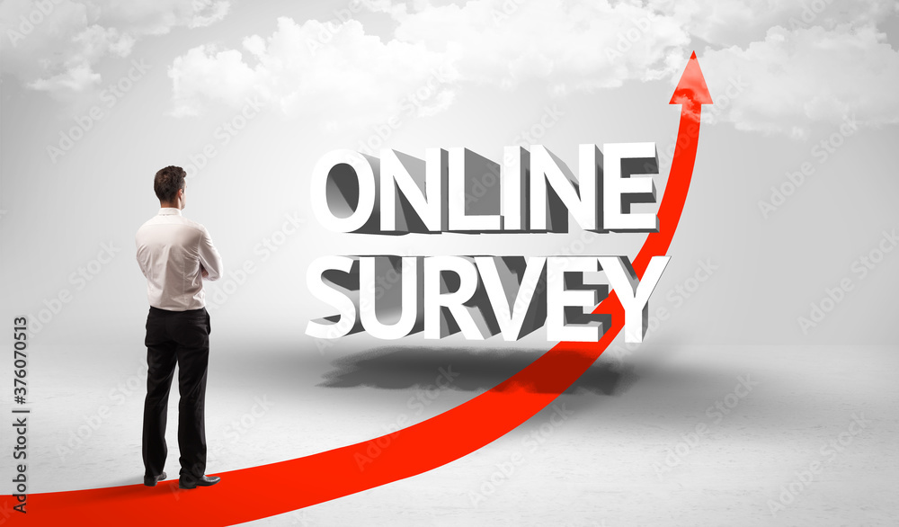 Fototapeta premium Rear view of a businessman standing in front of ONLINE SURVEY inscription, successful business concept